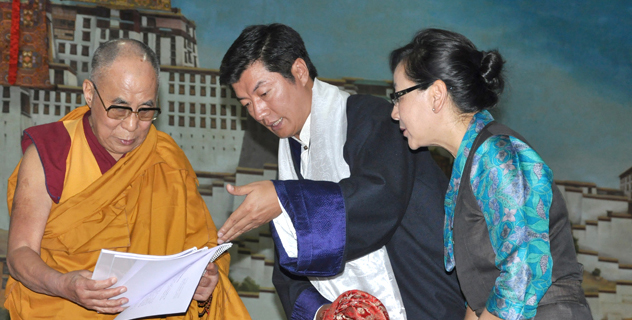 Tibetan political leader Dr Lobsang Sangay presents documents to His Holiness the Dalai Lama on Middle Way policy campaign at TCV school in Dharamsala, India, on 5 June 2014.. Also seen in the picture is Dicki Chhoyang, the Kalon for the Department of Information & International Relations of the Central Tibetan Administration, which is spearheading the Middle Way Approach Campaign/DIIR photo